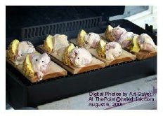 Chicken breasts and pineapple arranged on the cedar planks.